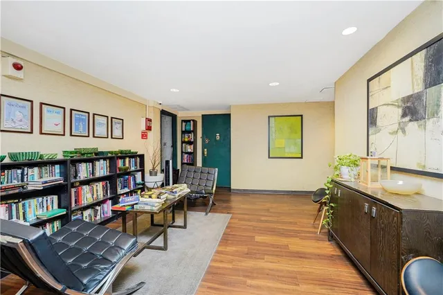 a living room with furniture and a book shelf