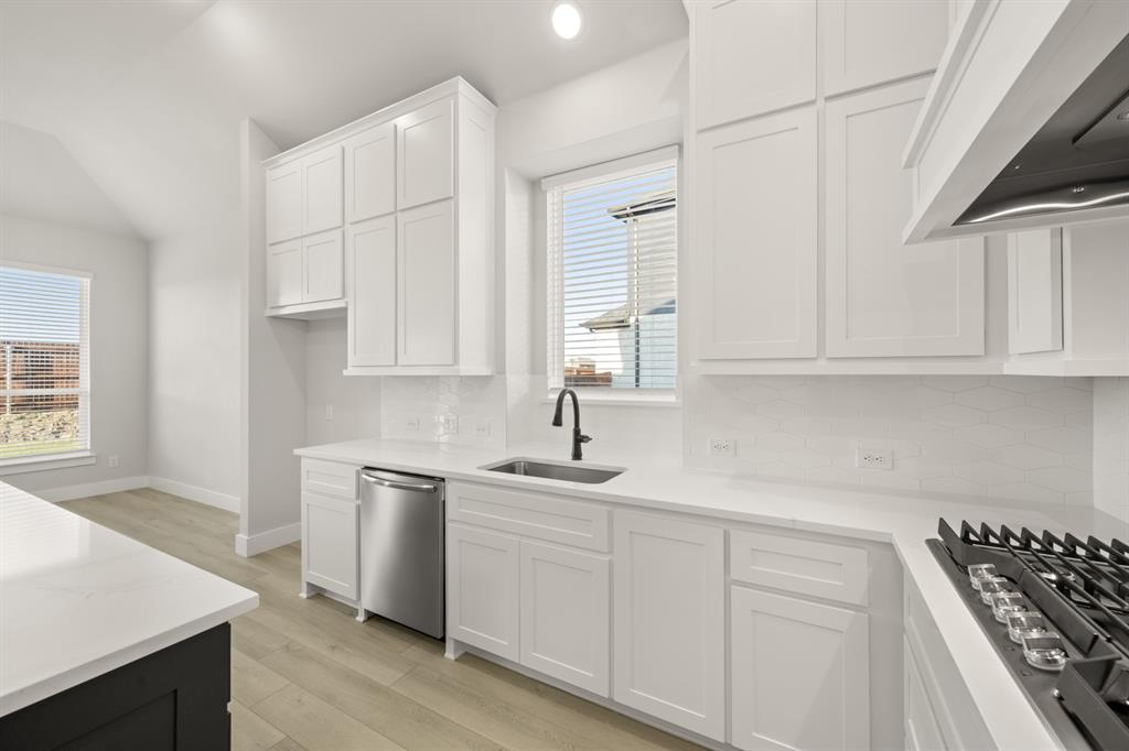 1104 Flock Drive Mansfield, TX 76063 - Photo 13 of 30 a kitchen with white cabinets sink and appliances