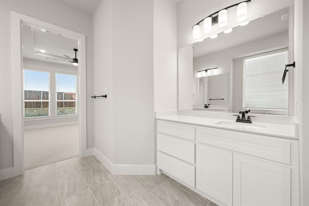 1104 Flock Drive Mansfield, TX 76063 - Photo 18 of 30 a bathroom with a double vanity sink and mirror