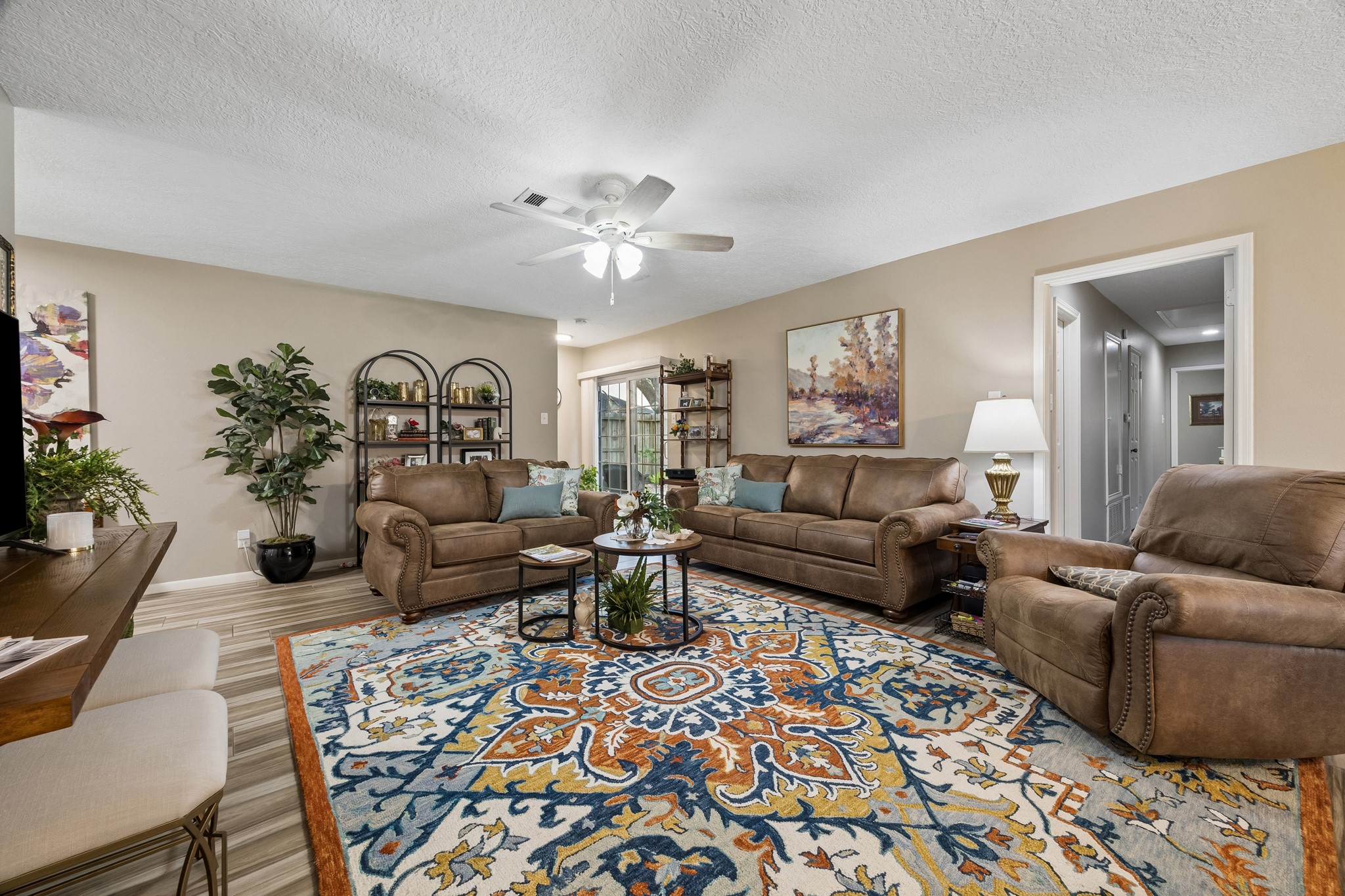 2102 Casa Rio Circle Dickinson, TX 77539 - Photo 4 of 22 Another view of the spacious living room showcasing the home's open layout and easy flow. Stunning floor-to-ceiling patio doors flood the space with natural light and provide a seamless connection to a private fully fenced backyard. Shows like a model home!!! ***Bonus ~ Floor to ceiling sliding glass door recently replaced by Seller ~ No popcorn ceilings in this 1975 condo, Seller had all ceilings smoothed out & repainted***