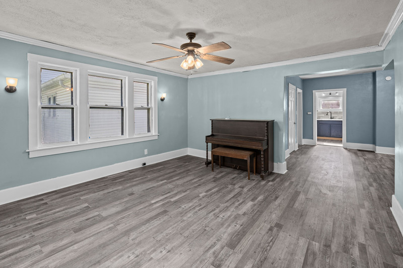 1419 17th Street Moline, IL 61265 - Photo 8 of 28 a view of empty room with wooden floor and fan