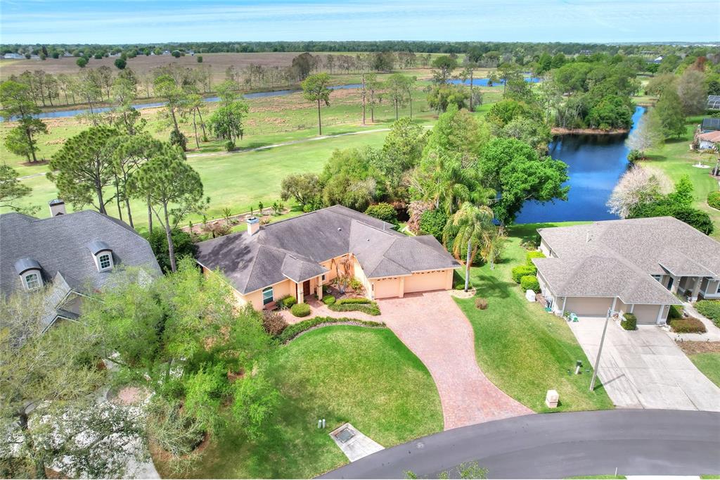 2968 Plantation Road Winter Haven, FL 33884 - Photo 3 of 81 an aerial view of green landscape with trees houses and lake view