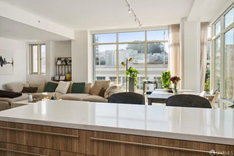 a living room with furniture and large windows