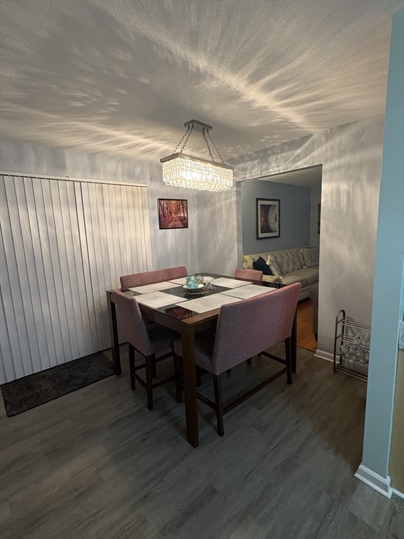 64 Wilmington Avenue Springfield, MA 01119 - Photo 13 of 29 a dining room with a table chairs and a wooden floor