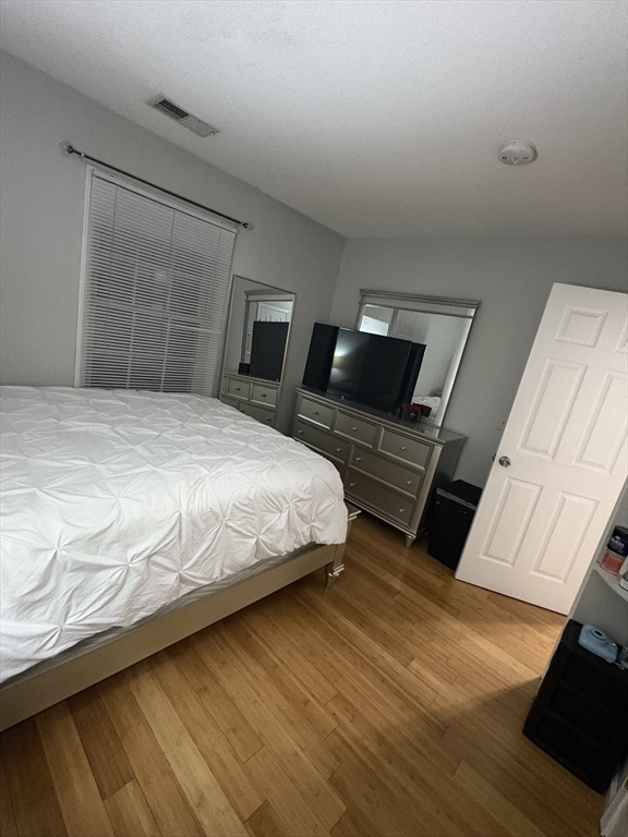 64 Wilmington Avenue Springfield, MA 01119 - Photo 15 of 29 a bedroom with a bed and wooden floor