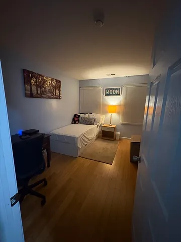 a bedroom with bed and window