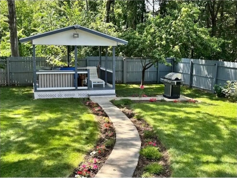 64 Wilmington Avenue Springfield, MA 01119 - Photo 2 of 29 a view of a deck with a table and chairs under an umbrella