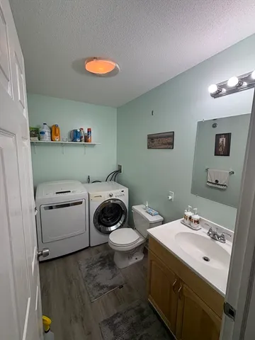 a bathroom with a sink toilet and a mirror