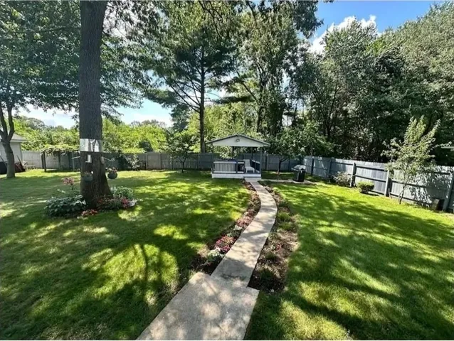 a view of a backyard with sitting area
