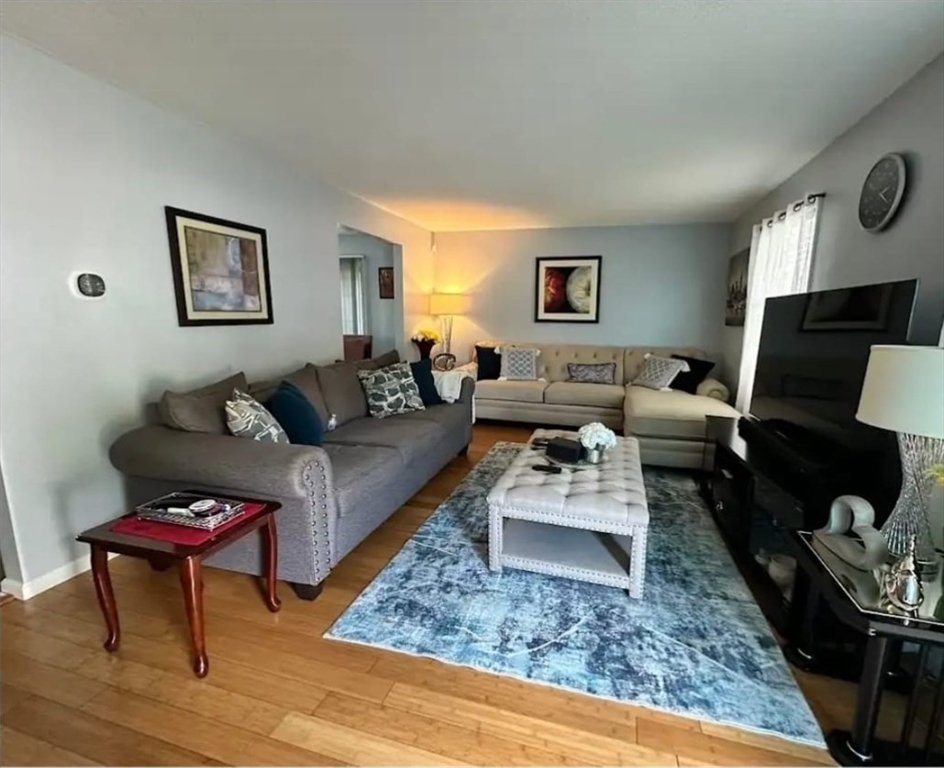 64 Wilmington Avenue Springfield, MA 01119 - Photo 5 of 29 a living room with furniture and wooden floor