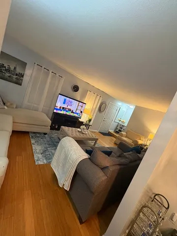 a living room with furniture and stairs