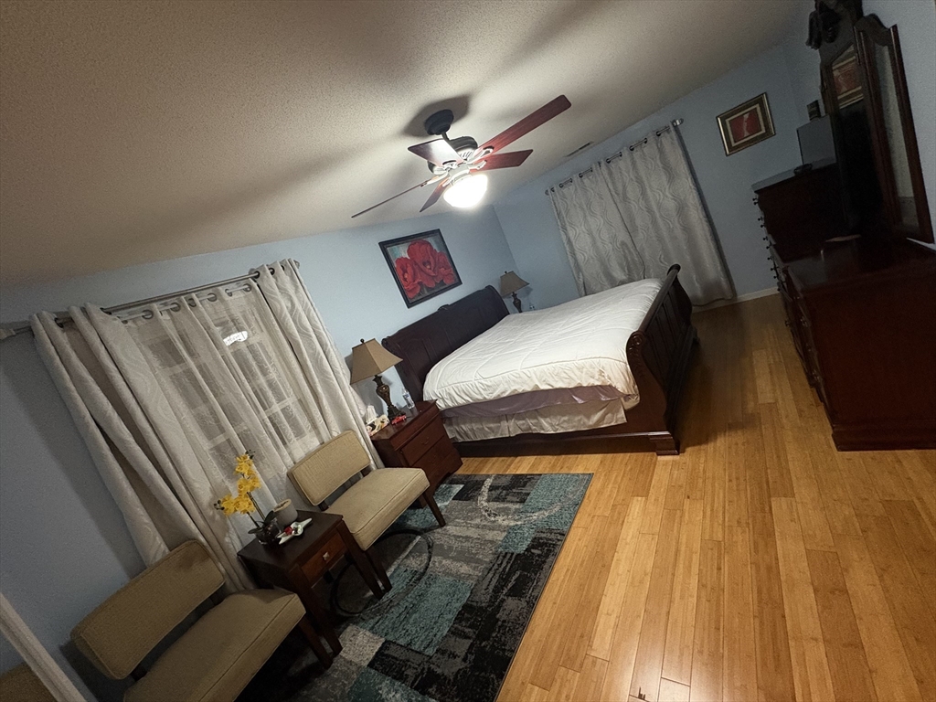 64 Wilmington Avenue Springfield, MA 01119 - Photo 10 of 29 a bedroom with a bed and wooden floor