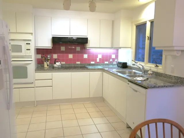 a kitchen with stainless steel appliances granite countertop a sink and cabinets