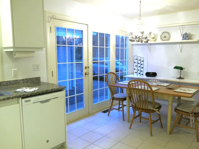 a view of a dining room with furniture and chandelier