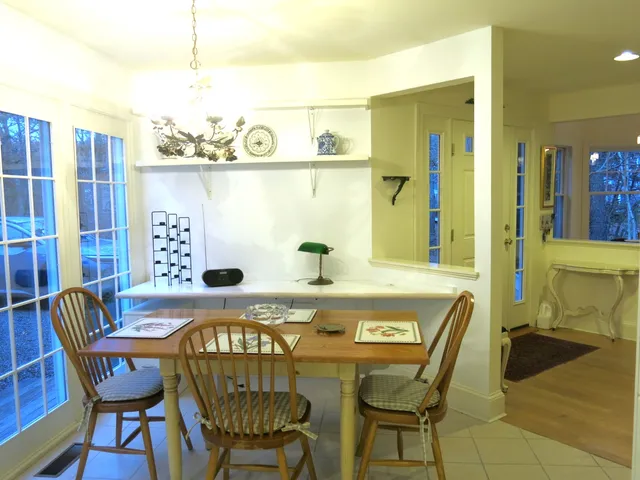 a view of a dining room with furniture and chandelier