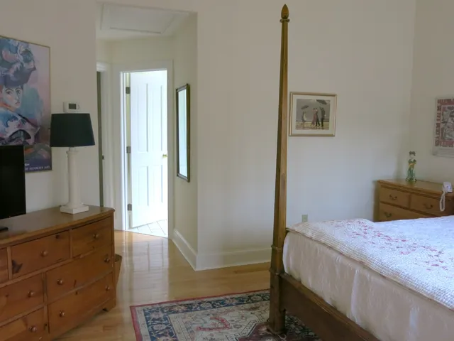 a bedroom with a bed and a dresser in it