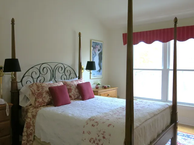 a bedroom with a bed and window