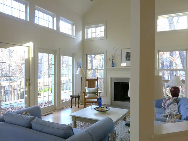 a living room with furniture fireplace and a large window