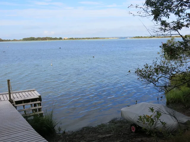 a view of a terrace with lawn chairs