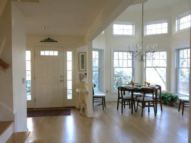 a view of a a dining room with furniture and wooden floor