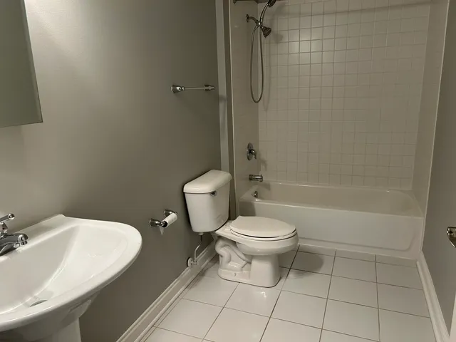 a bathroom with a toilet sink and shower