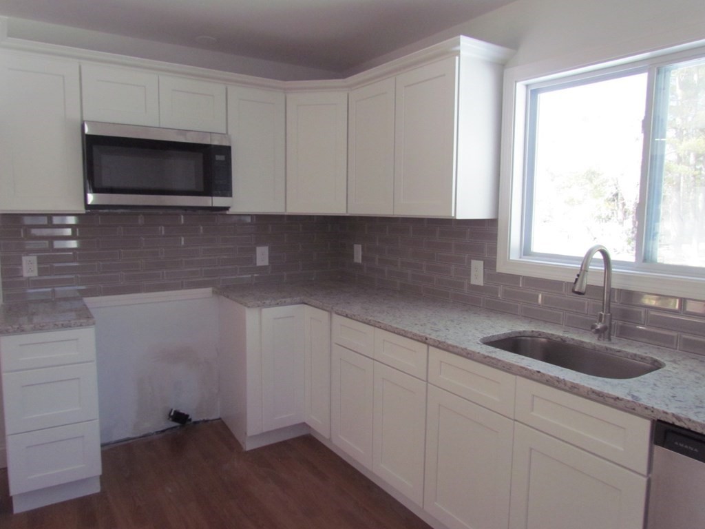 116 Williamsville Road Hubbardston, MA 01452 - Photo 13 of 27 a kitchen with granite countertop white cabinets and a sink