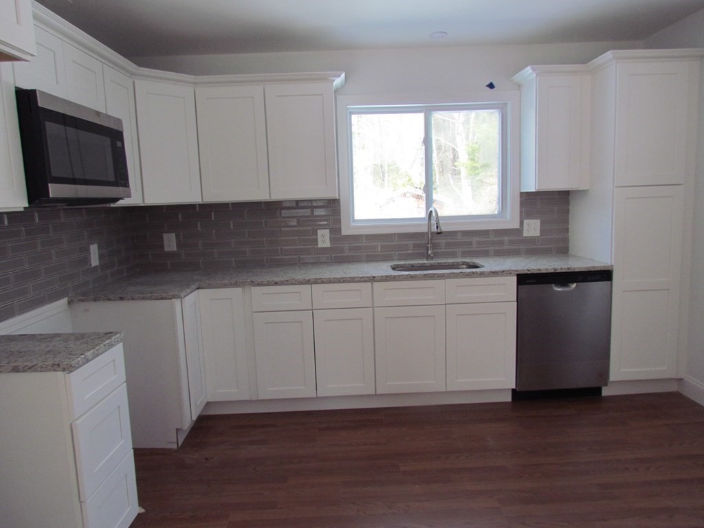 116 Williamsville Road Hubbardston, MA 01452 - Photo 17 of 27 a kitchen with stainless steel appliances granite countertop a sink a stove a microwave and cabinets