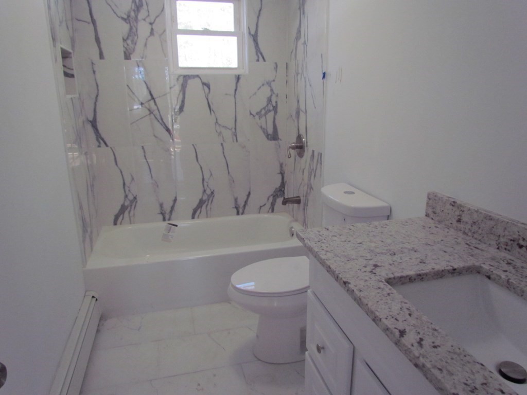116 Williamsville Road Hubbardston, MA 01452 - Photo 18 of 27 a bathroom with a granite countertop sink a toilet and bathtub