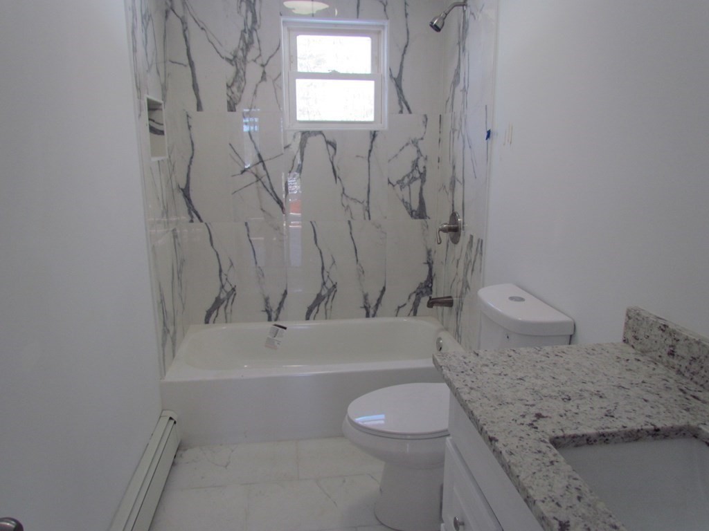 116 Williamsville Road Hubbardston, MA 01452 - Photo 19 of 27 a bathroom with a granite countertop white toilet and a shower