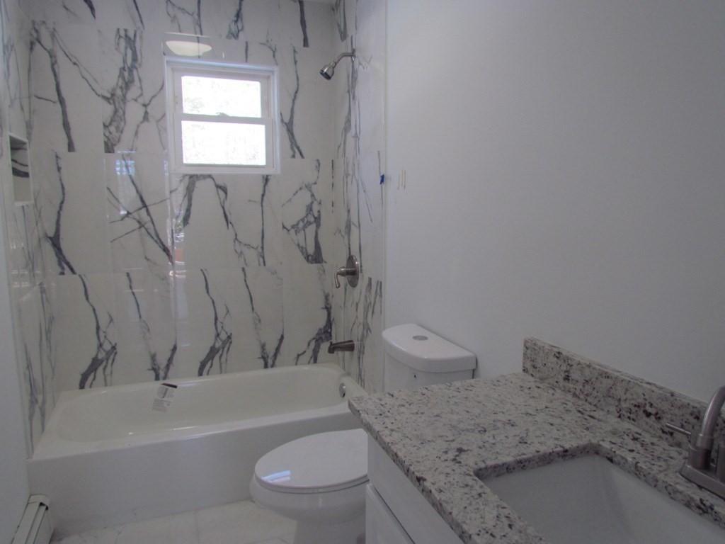 116 Williamsville Road Hubbardston, MA 01452 - Photo 20 of 27 a bathroom with a granite countertop toilet a sink and bathtub