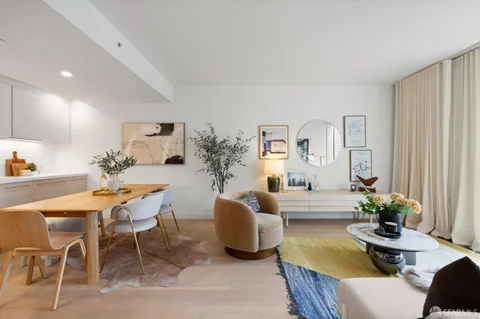 a living room with furniture potted plant and a window