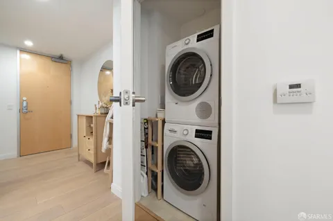 a view of a hallway with washer and dryer