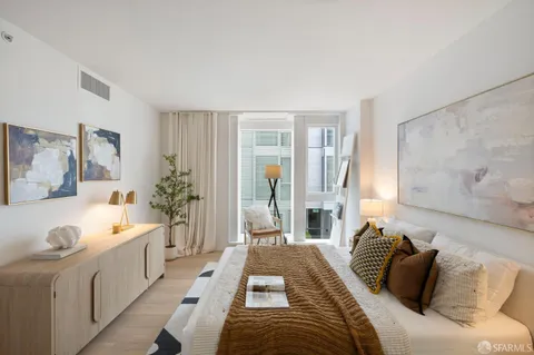 a spacious bedroom with a bed and a couch