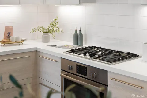 a white stove top oven sitting inside of a kitchen