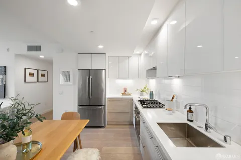 a kitchen with a sink refrigerator and microwave