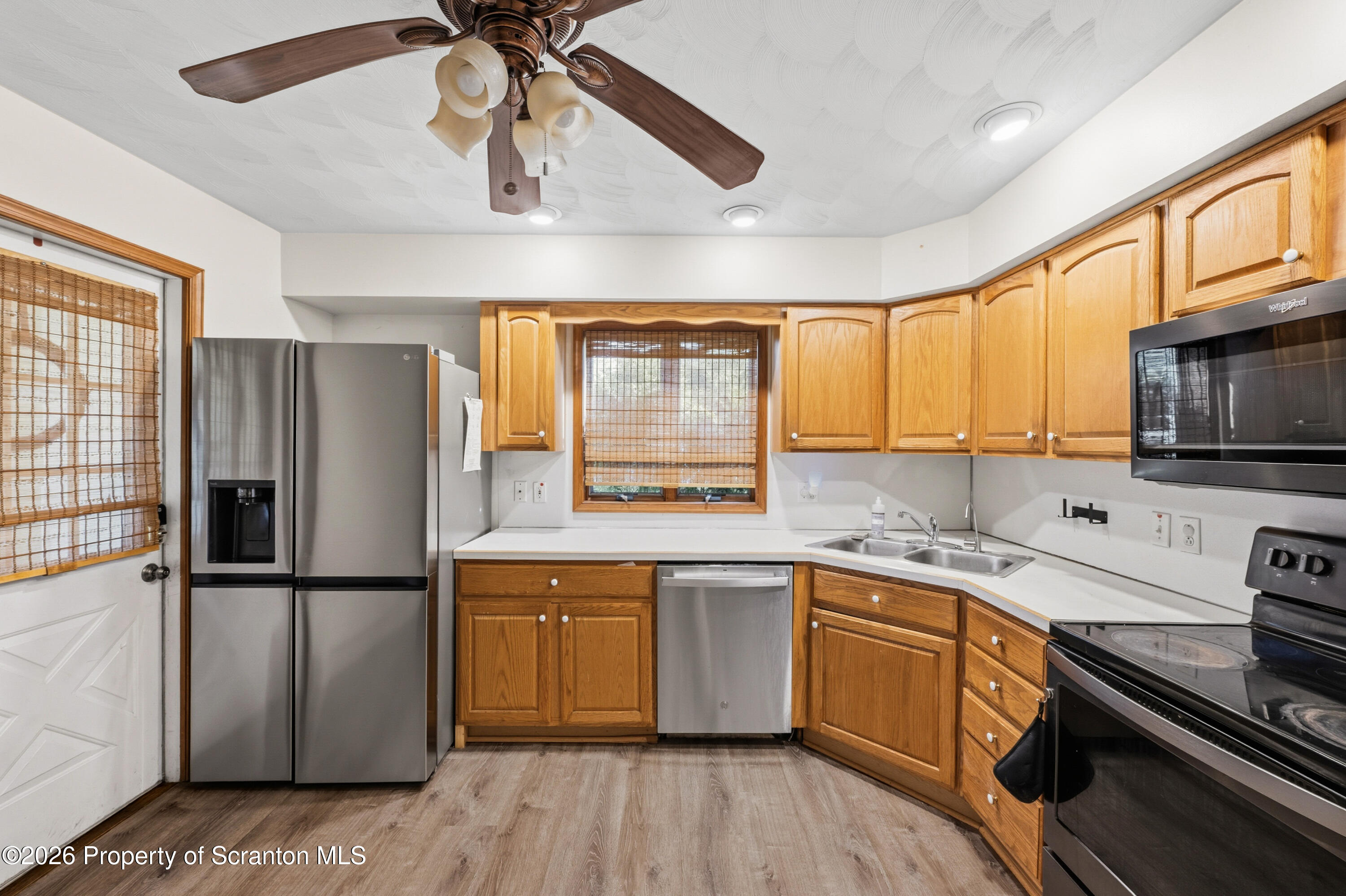 435 Foote Avenue Duryea, PA 18642 - Photo 15 of 51 a kitchen with stainless steel appliances granite countertop a refrigerator a sink dishwasher a stove and white countertops with wooden floor