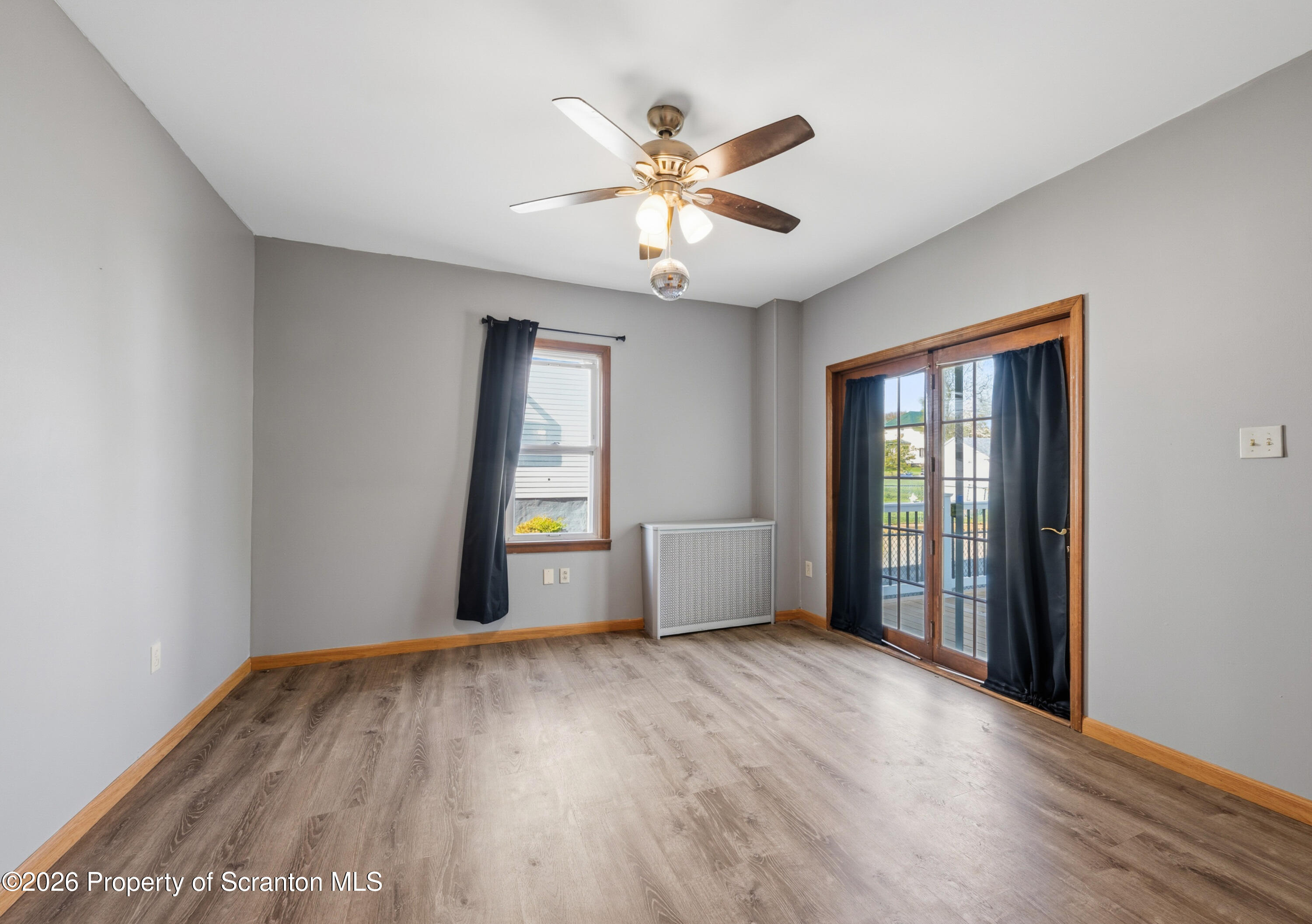 435 Foote Avenue Duryea, PA 18642 - Photo 17 of 51 an empty room with wooden floor fan and windows