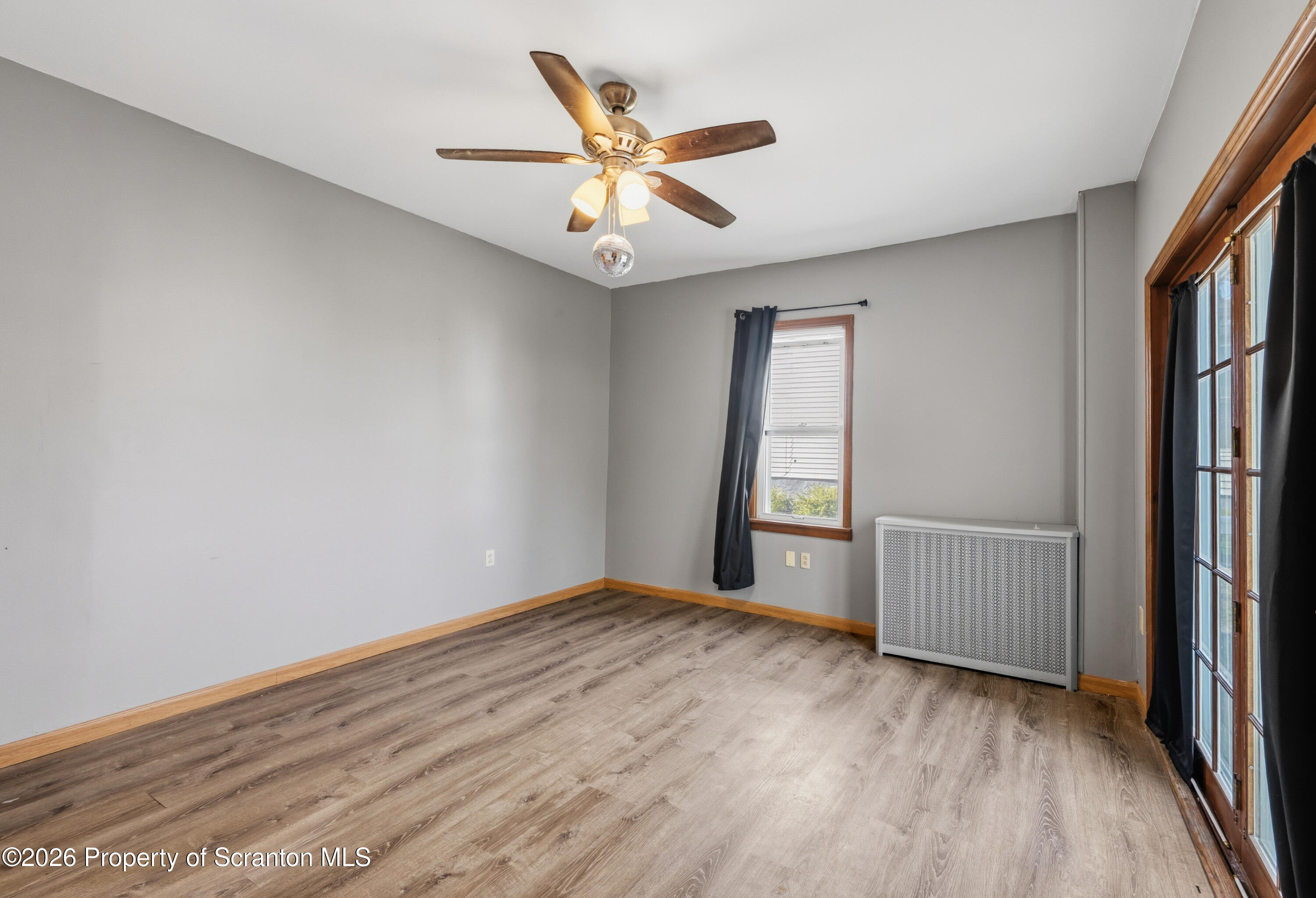 435 Foote Avenue Duryea, PA 18642 - Photo 18 of 51 an empty room with wooden floor fan and windows