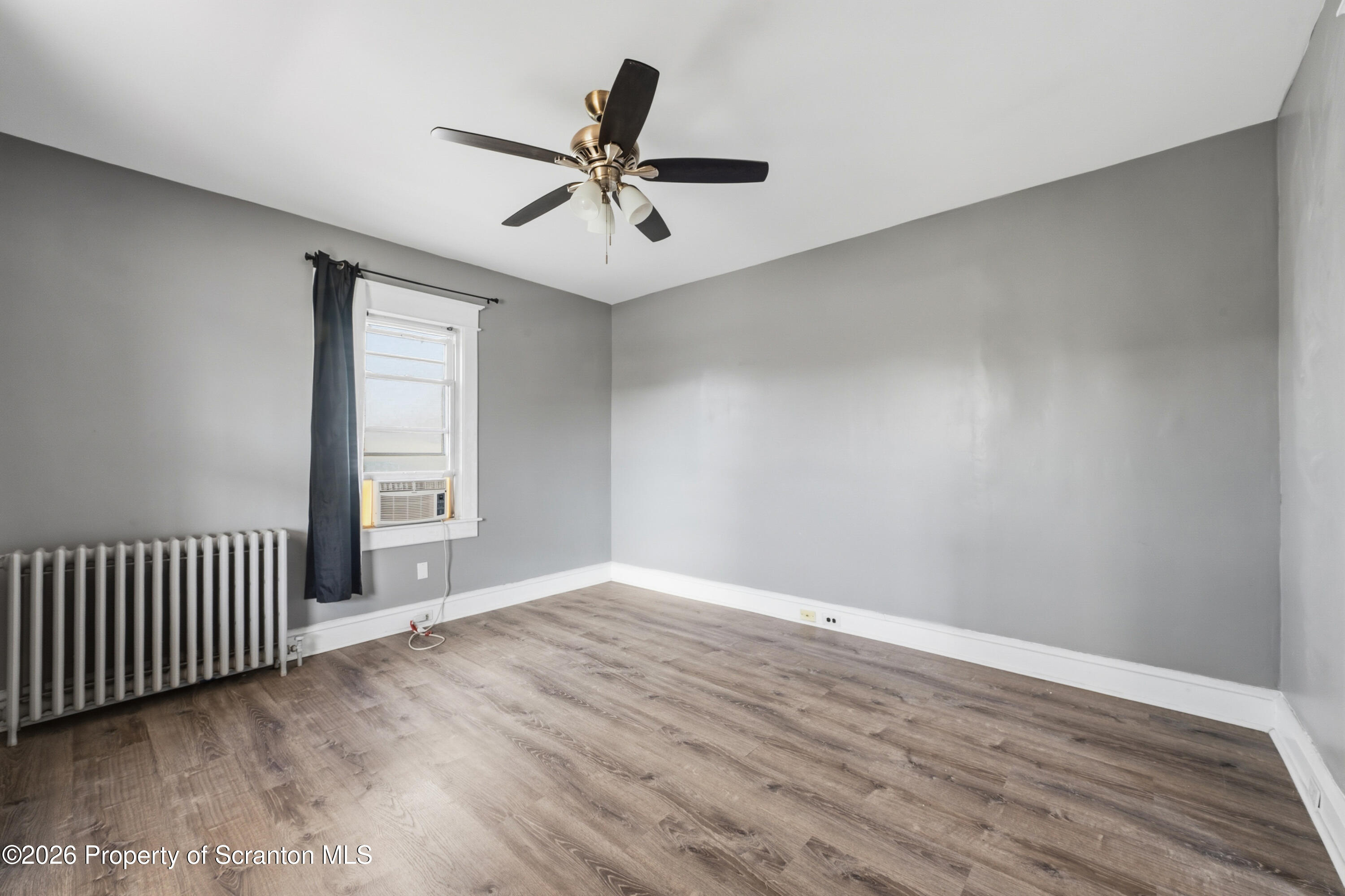 435 Foote Avenue Duryea, PA 18642 - Photo 19 of 51 an empty room with wooden floor fan and windows