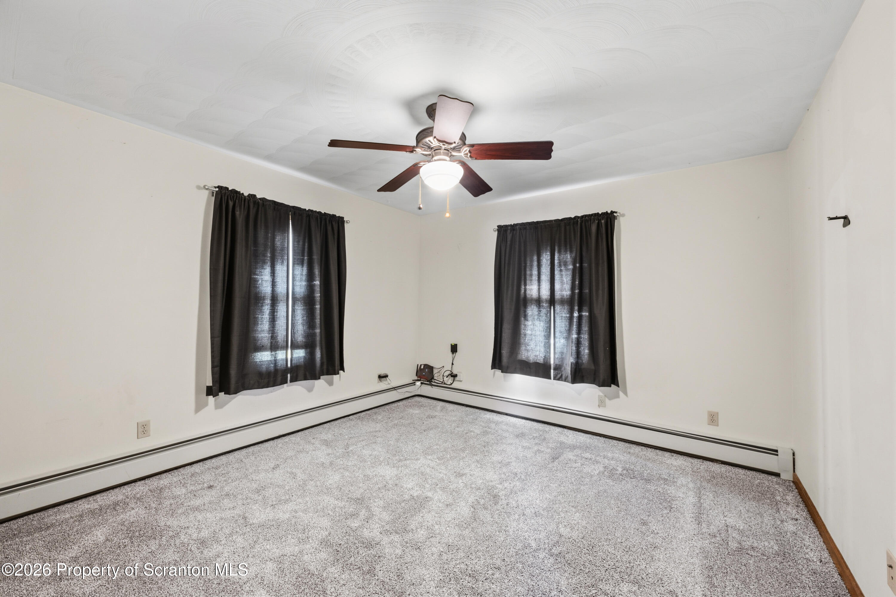 435 Foote Avenue Duryea, PA 18642 - Photo 29 of 51 a view of an empty room with window and chandelier fan