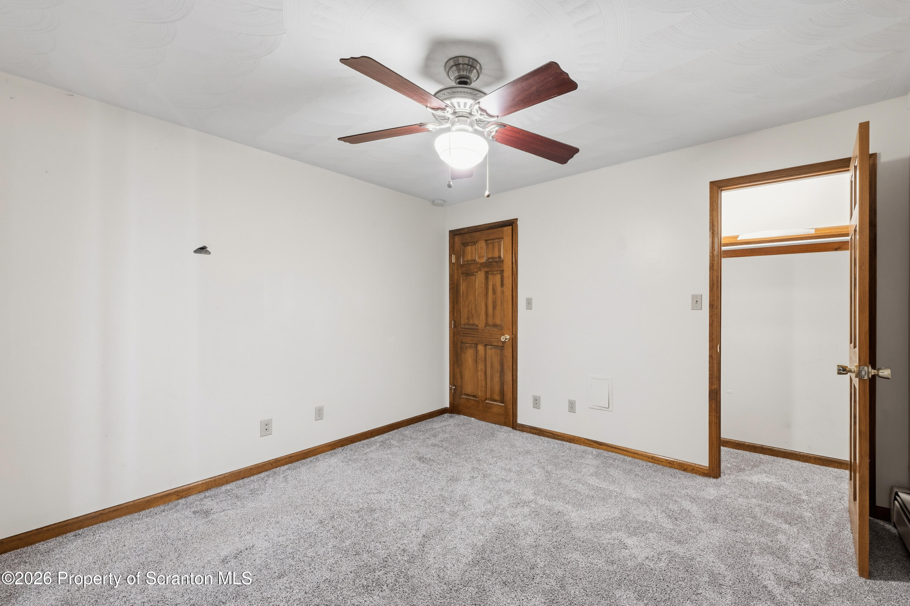 435 Foote Avenue Duryea, PA 18642 - Photo 30 of 51 an empty room with closet and a ceiling fan