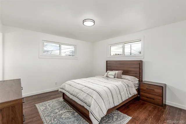 a bathroom with a granite countertop sink toilet a mirror and shower