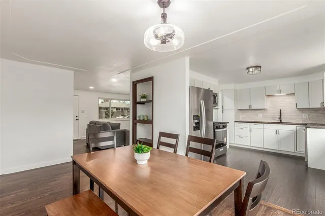 a view of a dining room with furniture wooden floor and a chandelier