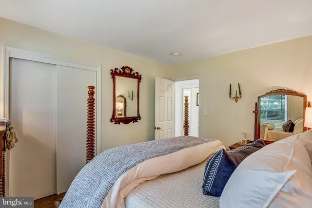 a bedroom with a bed and a mirror