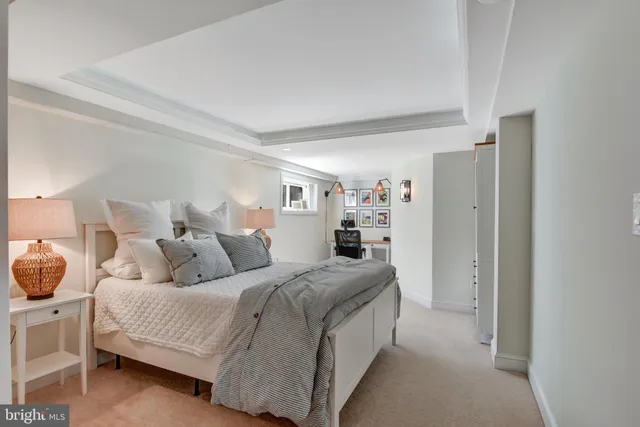 a living room with a bed and cabinets