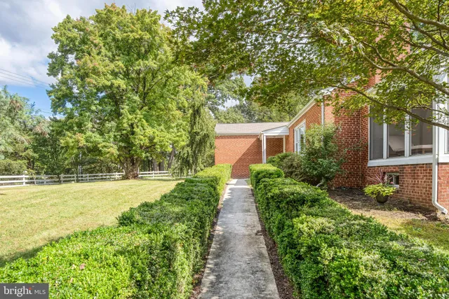 a view of a yard with wooden fence