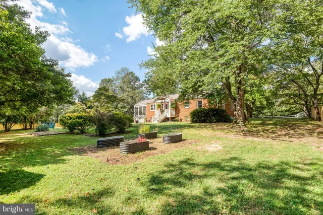 a view of yard with swimming pool and trees