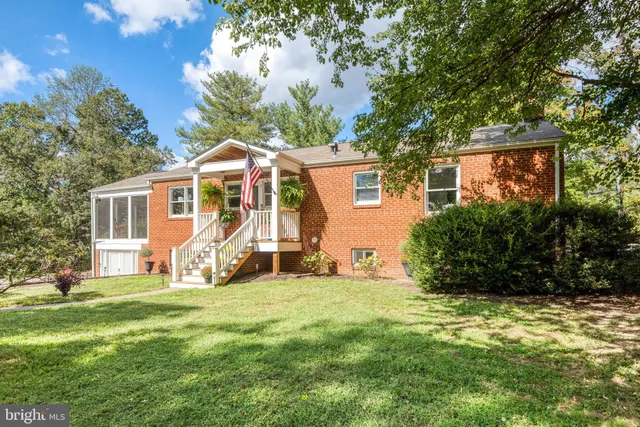 a view of a house with a yard and potted plants