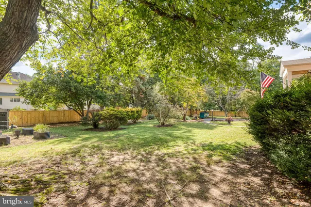 a view of a swimming pool with a patio and a yard