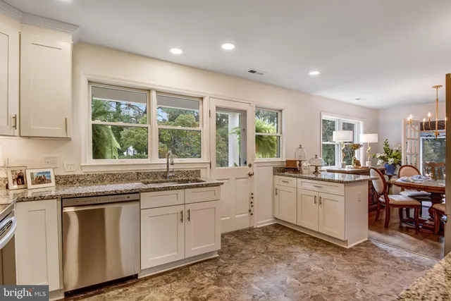a kitchen with sink cabinets and wooden floor